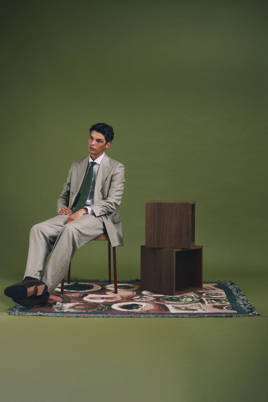 The Monterosa Loro Piana stone double-breasted wool suit worn seated