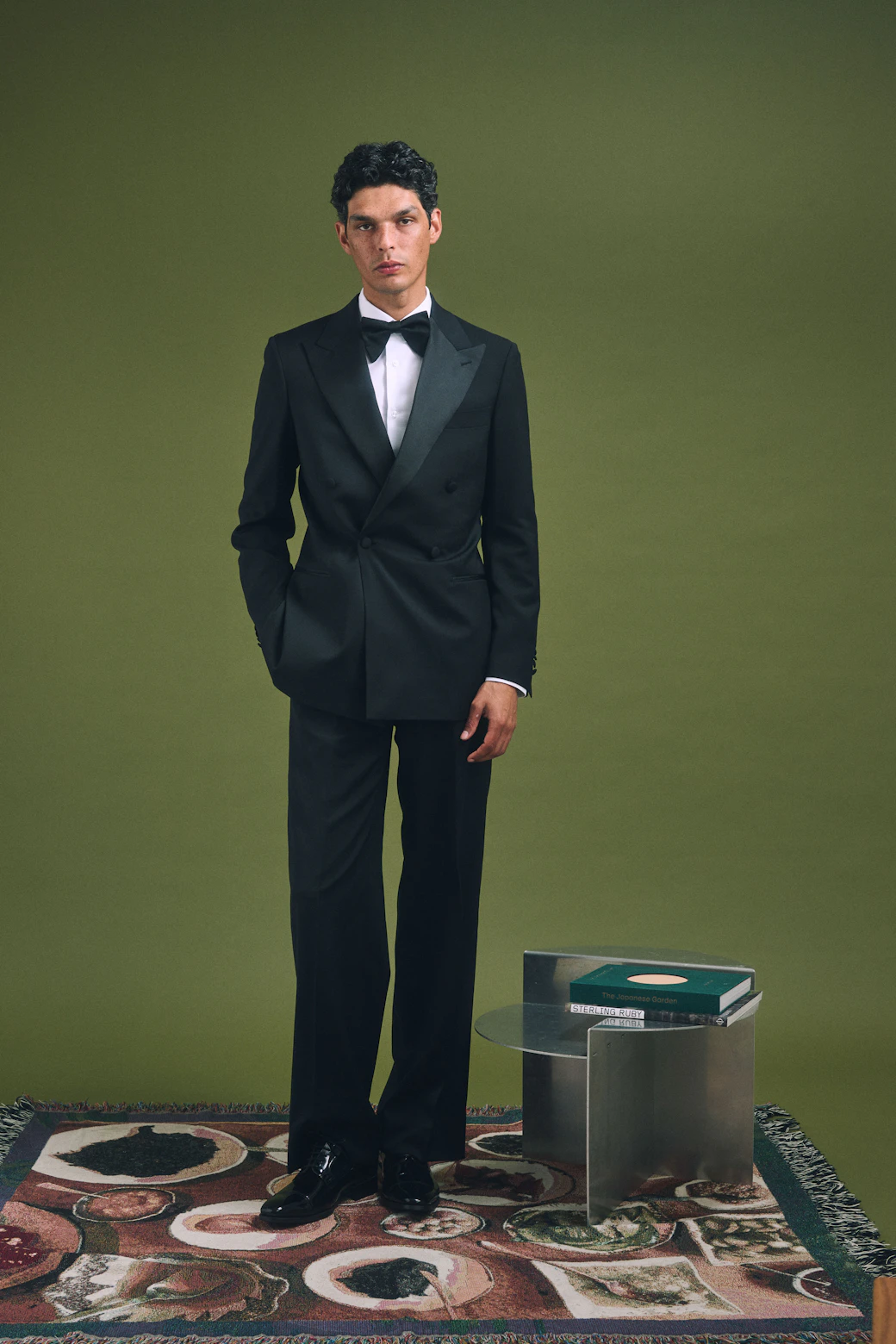 Full-length view of the Quarona Loro Piana black wool tuxedo