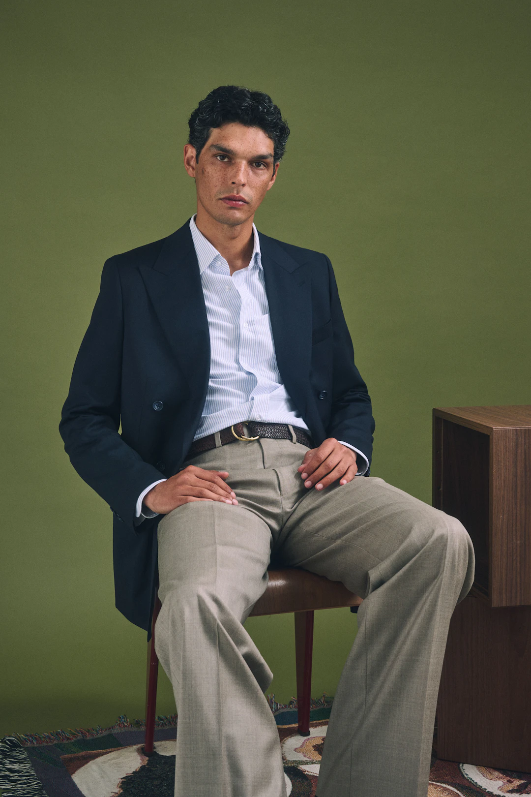 The Sesia navy double-breasted jacket worn seated