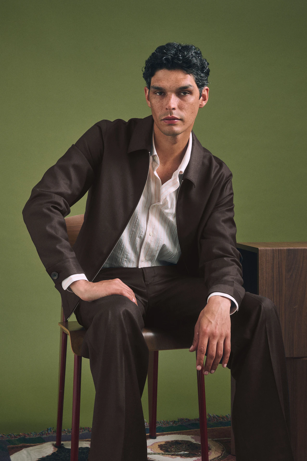 The Torino Loro Piana brown zip jacket and pants worn seated