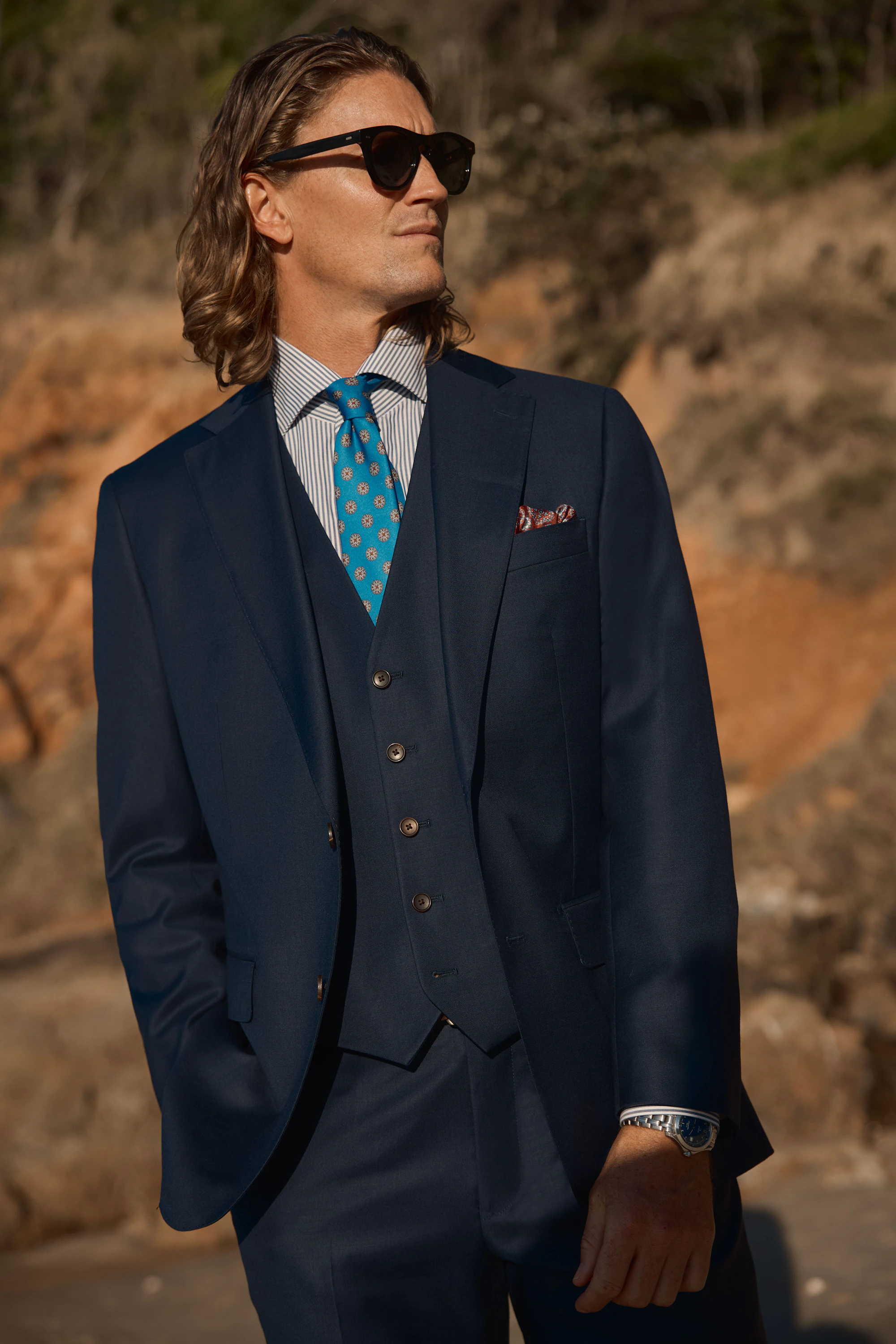 The Mackay navy wool three-piece suit with a teal patterned tie