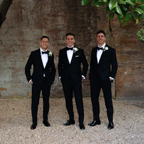 Groom and groomsmen wearing custom black tuxedos